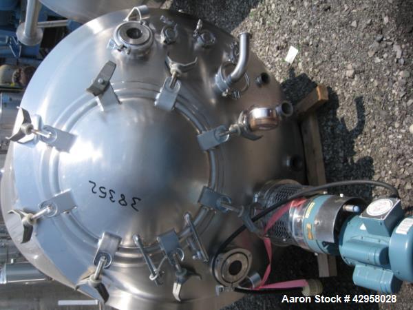 Used DCI tank, 1000 liters (250 gallons) 316L stainless steel constrution, approx. 42" diameter x 36" straight side, dished top and bottom with top entering .5 hp, 15/230 volt Lightnin agitator drive...