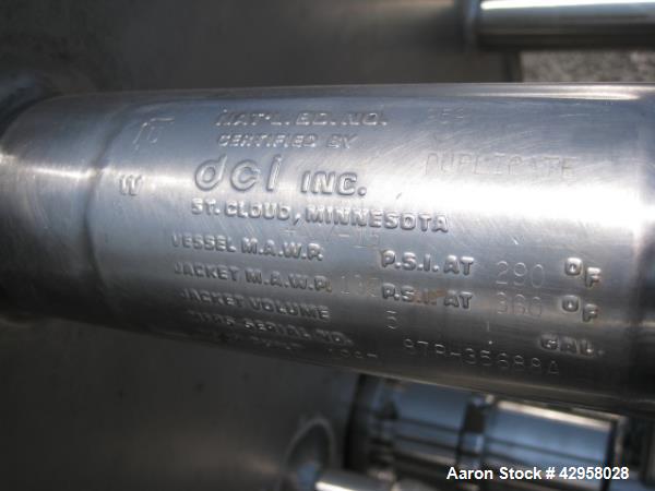 Used DCI tank, 1000 liters (250 gallons) 316L stainless steel constrution, approx. 42" diameter x 36" straight side, dished top and bottom with top entering .5 hp, 15/230 volt Lightnin agitator drive...