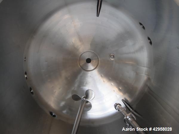 Used DCI tank, 1000 liters (250 gallons) 316L stainless steel constrution, approx. 42" diameter x 36" straight side, dished top and bottom with top entering .5 hp, 15/230 volt Lightnin agitator drive...