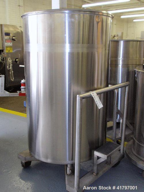 Used Tank, 250 Gallon, Stainless Steel, Vertical. 38" diameter x 58" staight side, open top with cover, flat bottom. 1-1/2" side bottom outlet. Mounted on a base with casters.