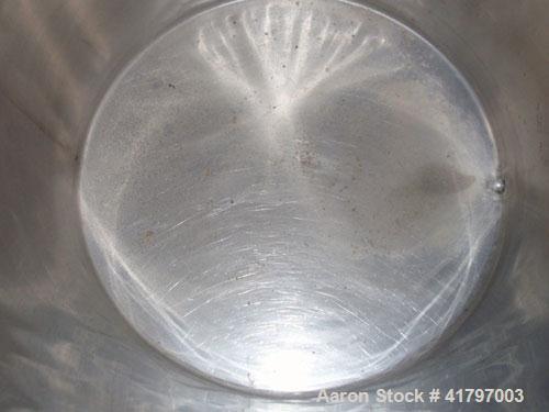 Used Tank, 125 Gallon, Stainless Steel, Vertical. 32" diameter x 40" staight side, open top with cover, flat bottom. 1" side bottom outlet. Mounted on a base with casters.