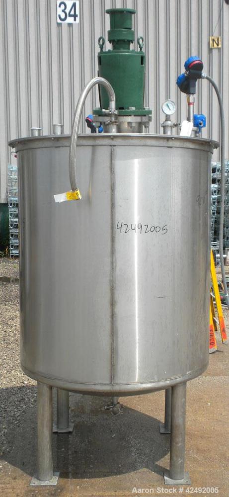 Used Tank, 440 Gallon, 304 Stainless Steel, Vertical. 48" Diameter x 52" straight side. Open top with a 2 piece cover, 1/2 bolt on, 1/2 clamp, dished bottom. Off center top entering Lightnin agitator...