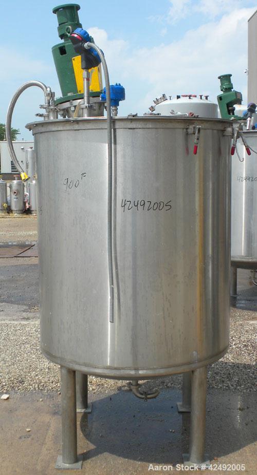 Used Tank, 440 Gallon, 304 Stainless Steel, Vertical. 48" Diameter x 52" straight side. Open top with a 2 piece cover, 1/2 bolt on, 1/2 clamp, dished bottom. Off center top entering Lightnin agitator...