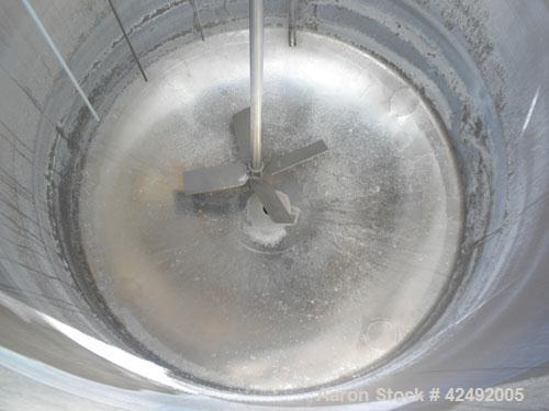 Used Tank, 440 Gallon, 304 Stainless Steel, Vertical. 48" Diameter x 52" straight side. Open top with a 2 piece cover, 1/2 bolt on, 1/2 clamp, dished bottom. Off center top entering Lightnin agitator...
