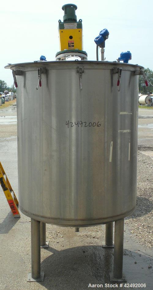 Used Tank, 440 Gallon, 304 Stainless Steel, Vertical. 48" Diameter x 52" straight side. Open top with a 2 piece cover, 1/2 bolt on, 1/2 clamp, dished bottom. Off center top entering Lightnin agitator...