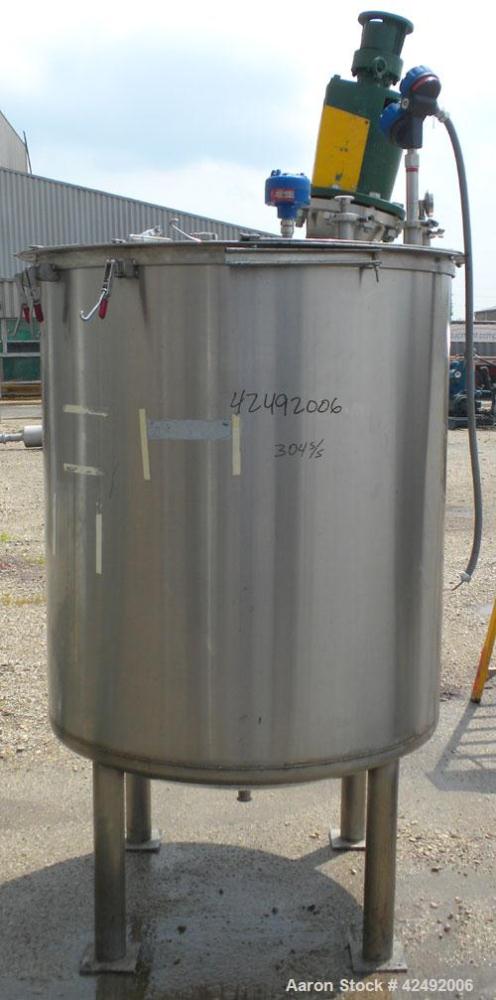 Used Tank, 440 Gallon, 304 Stainless Steel, Vertical. 48" Diameter x 52" straight side. Open top with a 2 piece cover, 1/2 bolt on, 1/2 clamp, dished bottom. Off center top entering Lightnin agitator...