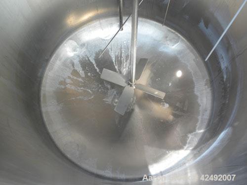 Used Tank, 440 Gallon, 304 Stainless Steel, Vertical. 48" Diameter x 52" straight side. Open top with a 2 piece cover, 1/2 bolt on, 1/2 clamp, dished bottom. Off center top entering Lightnin agitator...