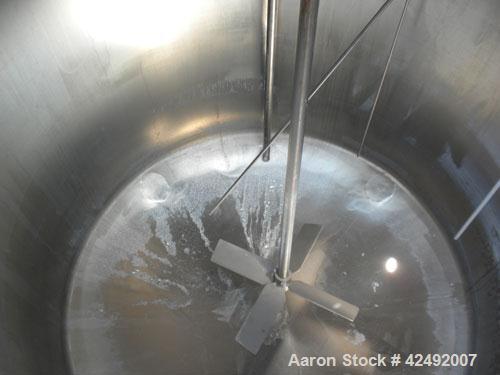 Used Tank, 440 Gallon, 304 Stainless Steel, Vertical. 48" Diameter x 52" straight side. Open top with a 2 piece cover, 1/2 bolt on, 1/2 clamp, dished bottom. Off center top entering Lightnin agitator...