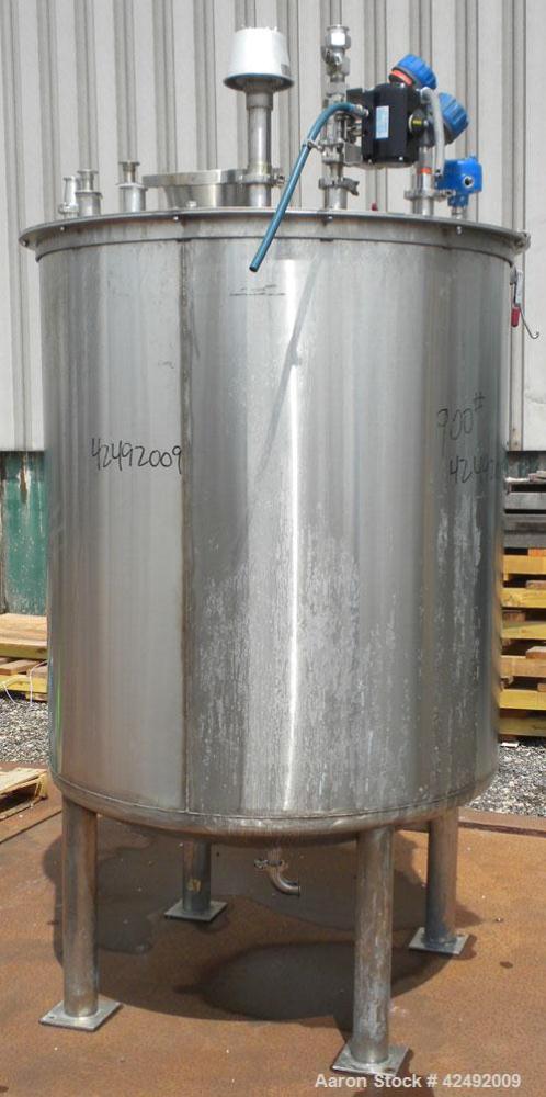 Used Tank, 440 Gallon, 304 Stainless Steel, Vertical. 48" Diameter x 52" straight side. Open top with a 2 piece cover, 1/2 bolt on, 1/2 clamp, dished bottom. Off center top entering Lightnin agitator...