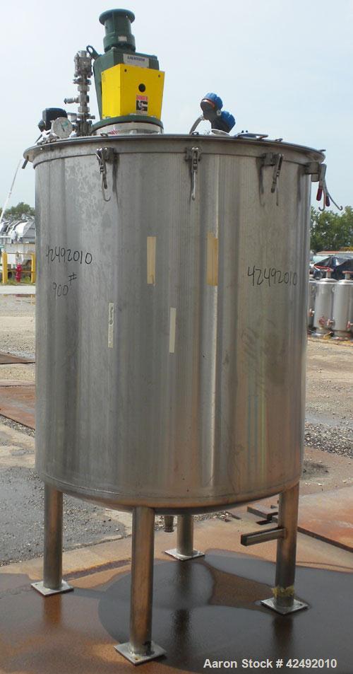 Used Tank, 440 Gallon, 304 Stainless Steel, Vertical. 48" Diameter x 52" straight side. Open top with a 2 piece cover, 1/2 bolt on, 1/2 clamp, dished bottom. Off center top entering Lightnin agitator...
