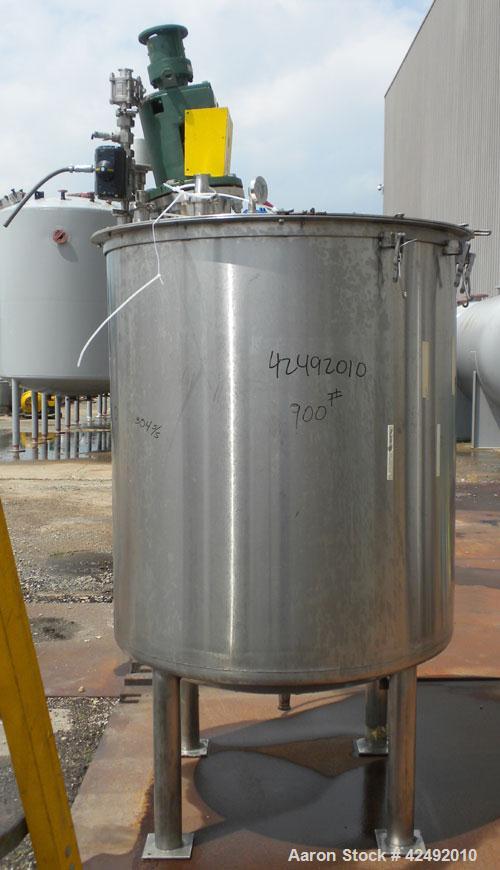 Used Tank, 440 Gallon, 304 Stainless Steel, Vertical. 48" Diameter x 52" straight side. Open top with a 2 piece cover, 1/2 bolt on, 1/2 clamp, dished bottom. Off center top entering Lightnin agitator...