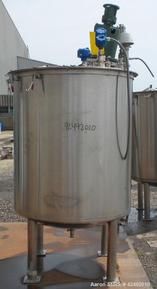 Used Tank, 440 Gallon, 304 Stainless Steel, Vertical. 48" Diameter x 52" straight side. Open top with a 2 piece cover, 1/2 bolt on, 1/2 clamp, dished bottom. Off center top entering Lightnin agitator...