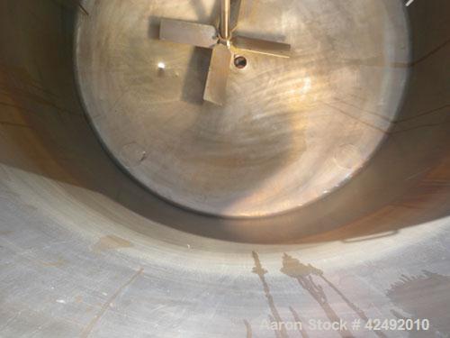 Used Tank, 440 Gallon, 304 Stainless Steel, Vertical. 48" Diameter x 52" straight side. Open top with a 2 piece cover, 1/2 bolt on, 1/2 clamp, dished bottom. Off center top entering Lightnin agitator...