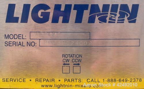 Used Tank, 440 Gallon, 304 Stainless Steel, Vertical. 48" Diameter x 52" straight side. Open top with a 2 piece cover, 1/2 bolt on, 1/2 clamp, dished bottom. Off center top entering Lightnin agitator...