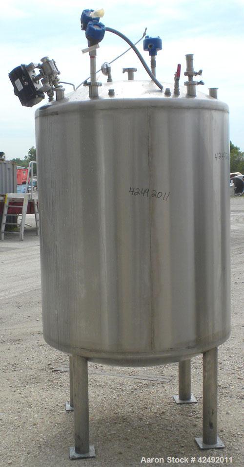 Used Tank, 440 Gallon, 304 Stainless Steel, Vertical. 48" Diameter x 52" straight side, dished top and bottom. Openings: top 1-1/2" tri-clamp, (5) 2" tri-clamp, 12" manway with a 4" tri-clamp in the ...