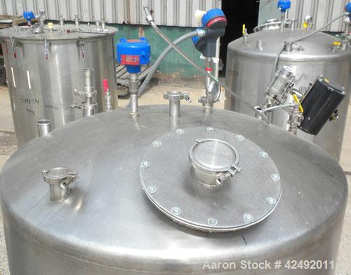 Used Tank, 440 Gallon, 304 Stainless Steel, Vertical. 48" Diameter x 52" straight side, dished top and bottom. Openings: top 1-1/2" tri-clamp, (5) 2" tri-clamp, 12" manway with a 4" tri-clamp in the ...