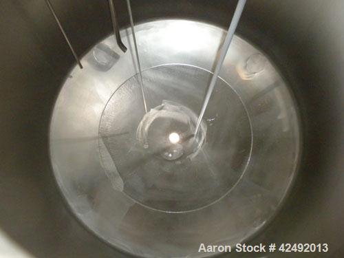 Used Tank, 440 Gallon, 304 Stainless Steel, Vertical. 48" Diameter x 52" straight side, dished top and bottom. Openings: top 1-1/2" tri-clamp, (5) 2" tri-clamp, 12" manway with a 4" tri-clamp in the ...