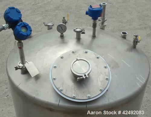 Used Tank, 440 Gallon, 304 Stainless Steel, Vertical. 48" Diameter x 52" straight side, dished top and bottom. Openings: top 1-1/2" tri-clamp, (5) 2" tri-clamp, 12" manway with a 4" tri-clamp in the ...