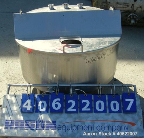Used Tank, approximate 70 gallon, 316 stainless steel, vertical. Approximate 37" diameter x 15" straight side.  1 piece angled hinged top cover, sloped bottom. Openings: top (3) 2" triclamp, 6 1/2"; ...