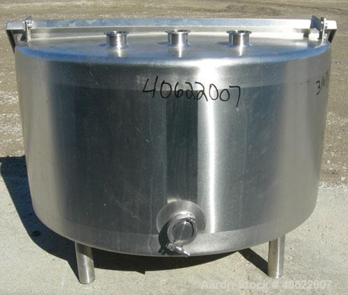 Used Tank, approximate 70 gallon, 316 stainless steel, vertical. Approximate 37" diameter x 15" straight side.  1 piece angled hinged top cover, sloped bottom. Openings: top (3) 2" triclamp, 6 1/2"; ...