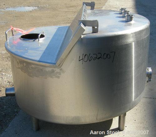Used Tank, approximate 70 gallon, 316 stainless steel, vertical. Approximate 37" diameter x 15" straight side.  1 piece angled hinged top cover, sloped bottom. Openings: top (3) 2" triclamp, 6 1/2"; ...
