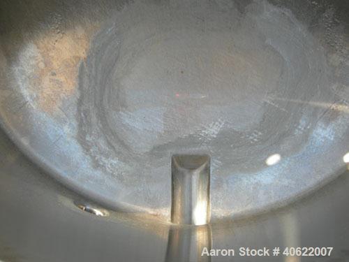 Used Tank, approximate 70 gallon, 316 stainless steel, vertical. Approximate 37" diameter x 15" straight side.  1 piece angled hinged top cover, sloped bottom. Openings: top (3) 2" triclamp, 6 1/2"; ...