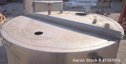 Used Tank, Approximately 400 Gallon, 304 Stainless Steel, Vertical. 57" diameter x 38" striaght side. Flat top with 2 piece hinged top cover, flat bottom. 1 1/2" end bottom outlet.  Mounted on 4 stai...