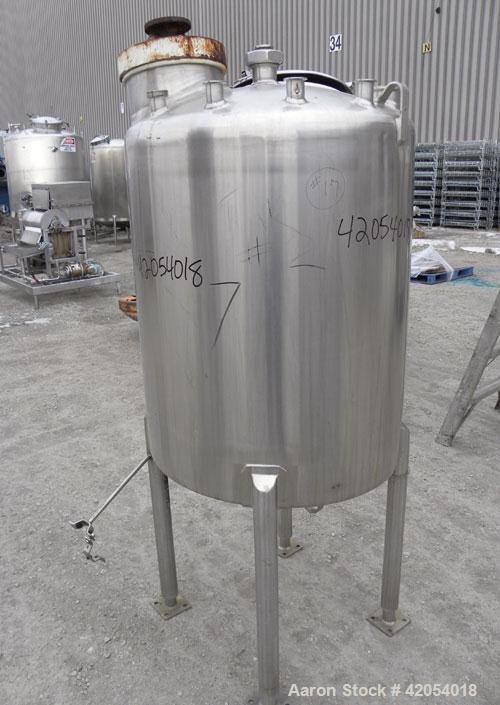 Used Tank, 100 Gallon, 316 Stainless Steel, Vertical. 30" diameter x 36" straight side, dish top, sloped bottom. 1-1/4" diameter shaft with a 3 blade prop, requires drive. Openings top (6) 1-1/2", 3"...