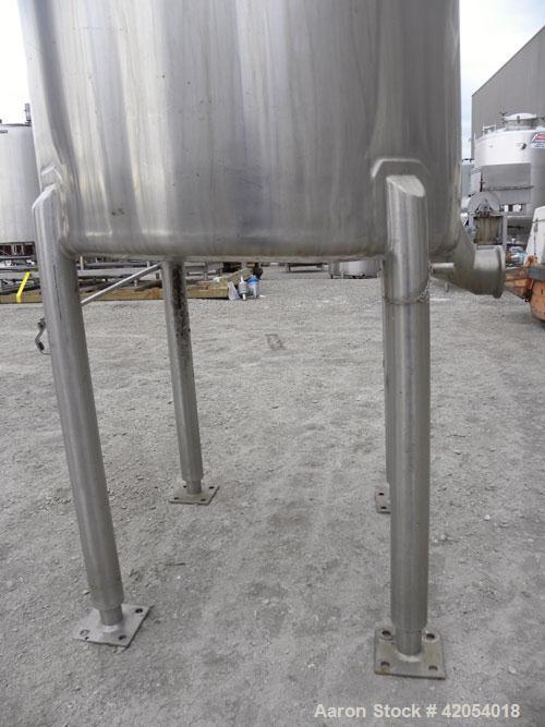 Used Tank, 100 Gallon, 316 Stainless Steel, Vertical. 30" diameter x 36" straight side, dish top, sloped bottom. 1-1/4" diameter shaft with a 3 blade prop, requires drive. Openings top (6) 1-1/2", 3"...