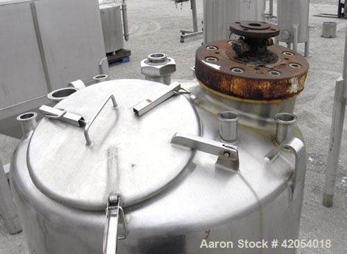 Used Tank, 100 Gallon, 316 Stainless Steel, Vertical. 30" diameter x 36" straight side, dish top, sloped bottom. 1-1/4" diameter shaft with a 3 blade prop, requires drive. Openings top (6) 1-1/2", 3"...