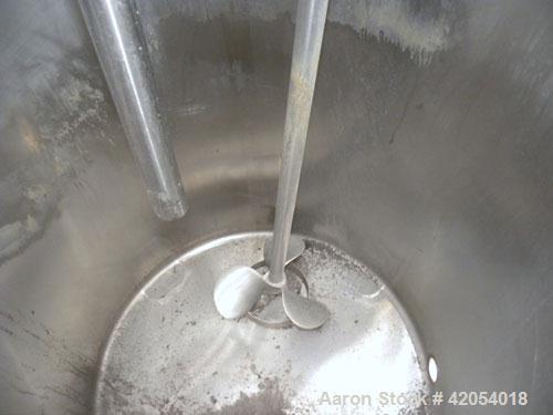 Used Tank, 100 Gallon, 316 Stainless Steel, Vertical. 30" diameter x 36" straight side, dish top, sloped bottom. 1-1/4" diameter shaft with a 3 blade prop, requires drive. Openings top (6) 1-1/2", 3"...