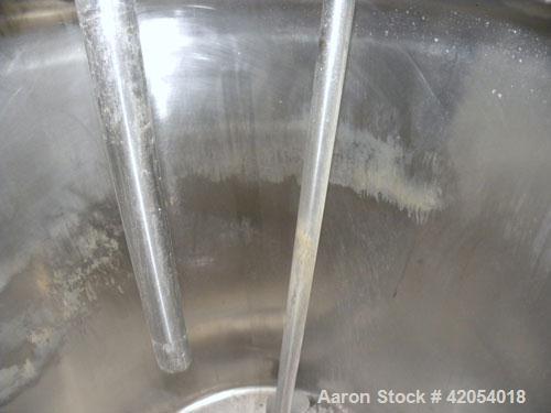 Used Tank, 100 Gallon, 316 Stainless Steel, Vertical. 30" diameter x 36" straight side, dish top, sloped bottom. 1-1/4" diameter shaft with a 3 blade prop, requires drive. Openings top (6) 1-1/2", 3"...