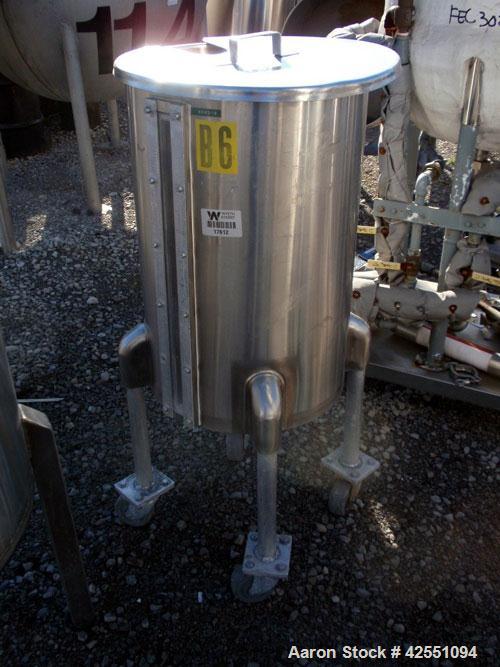 Used Tank, 30 Gallon, Stainless Steel. Approximate 18" diameter x 28" straight side, open top with cover, dished bottom, 1" center bottom outlet, on stainless steel legs with casters.