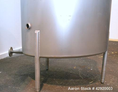 Used Tank, 190 Gallon, 316 Stainless Steel, Vertical. 3/4 Closed top with an “L” shaped opening with cover, sloped bottom. Openings side 2’’ tri-clamp, 3’’ tri-clamp, 1-1/2’’ side bottom outlet. Moun...