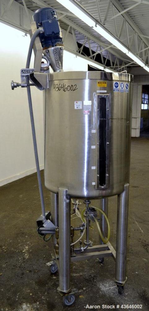 Used Tank, 90 Gallon, 304 Stainless Steel, Vertical. Approximate 28" diameter x 32" straight side. Flat top with a 1/2 hinged cover, dished bottom. Sidewall sight glass. Clamp on Agimex agitator, mod...
