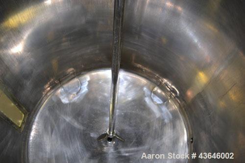 Used Tank, 90 Gallon, 304 Stainless Steel, Vertical. Approximate 28" diameter x 32" straight side. Flat top with a 1/2 hinged cover, dished bottom. Sidewall sight glass. Clamp on Agimex agitator, mod...