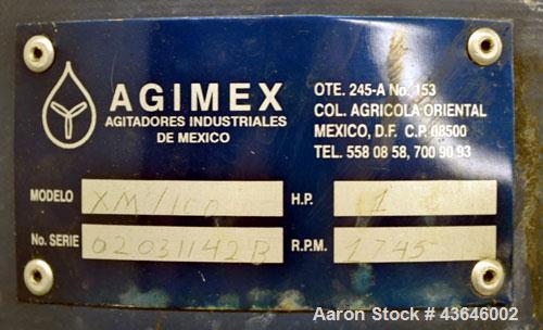 Used Tank, 90 Gallon, 304 Stainless Steel, Vertical. Approximate 28" diameter x 32" straight side. Flat top with a 1/2 hinged cover, dished bottom. Sidewall sight glass. Clamp on Agimex agitator, mod...