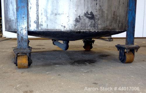 Used Tank, 300 Gallons, 301 Stainless Steel, Vertical. Approximate 48" diameter x 40" straight side, open top, no cover, coned bottom. 2" Center bottom outlet. Mounted on a carbon steel legs with cas...
