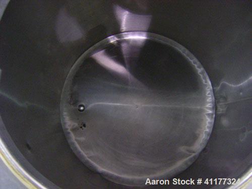 Used Perma-San Tank, 150 gallon, stainless steel, vertical. Closed top with manway, sloped bottom. Mounted on 3 legs with casters.