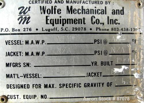 USED: Wolfe mechanical tank, 275 gallon, 304 stainless steel, vertical. Approximate 36" diameter x 60" straight side. Flat top, dish bottom. Openings: top (3) 2", (2) 3"; 2" center bottom outlet. (4)...