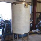 Unused- Sanitary Construction Tank, Approximately 200 Gallon, Vertical. Dish top and bottom. Mounted on 3' legs. Approximate...