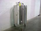 Used Perma-San Tank, 150 gallon, stainless steel, vertical. Closed top with manway, sloped bottom. Mounted on 3 legs with casters.