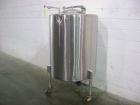 Used Perma-San Tank, 150 gallon, stainless steel, vertical. Closed top with manway, sloped bottom. Mounted on 3 legs with casters.