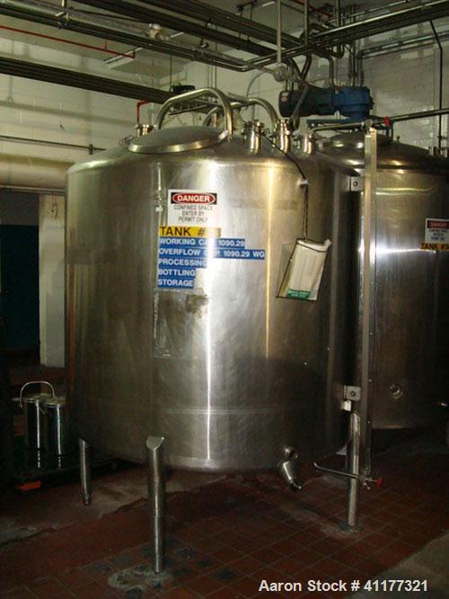 Used DCI 1000 gallon single wall vertical mixing tank. 6' diameter x 5' straightwall x 10' overall height. (4) stainless steel legs, sight glass, (3) 4" inlets, 2" and 3" front bottom front outlets. ...