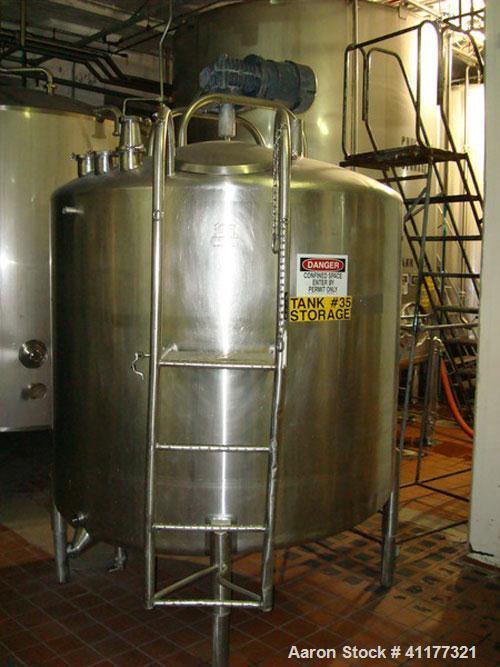 Used DCI 1000 gallon single wall vertical mixing tank. 6' diameter x 5' straightwall x 10' overall height. (4) stainless steel legs, sight glass, (3) 4" inlets, 2" and 3" front bottom front outlets. ...