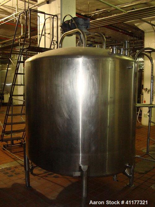 Used DCI 1000 gallon single wall vertical mixing tank. 6' diameter x 5' straightwall x 10' overall height. (4) stainless steel legs, sight glass, (3) 4" inlets, 2" and 3" front bottom front outlets. ...