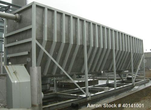 Used: Moon Fabricators 316 stainless steel tank, rectangular, with bottom screw conveyor discharge. Year 2000, serial #B-8025. With 1,000 gallon stainless steel tank.