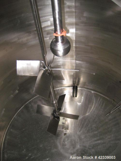 Used Tank, 1,100  Gallon, stainless steel, 66" diameter x 70" straight side.  Vertical, slight cone top, flat / pitched bottom.  Top mounted / off center 1 hp agitator, 1745 rpm, connected to a 2" di...