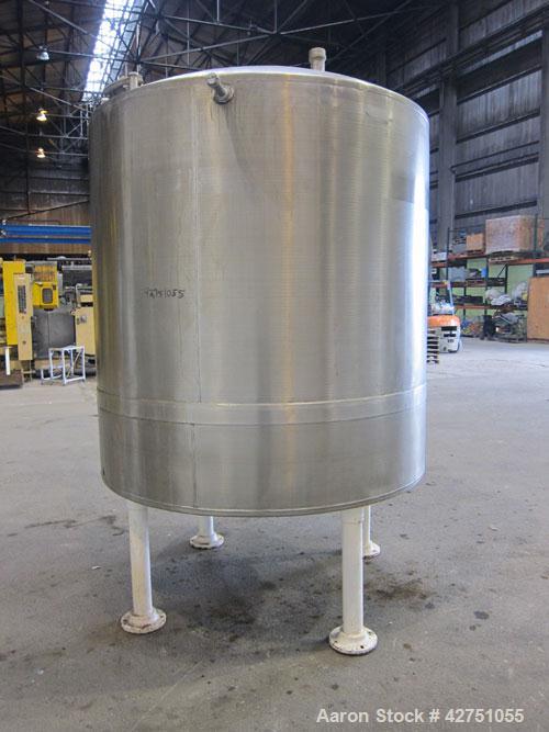 Used Tank, 1000 Gallon, 304 Stainless Steel, Vertical. 66" Diameter x 66" straight side, dished top, coned bottom. Openings top 1-1/2", (2) 2" NPT, (2) 3", 18" man way with cover. 2" Tri-clamp center...