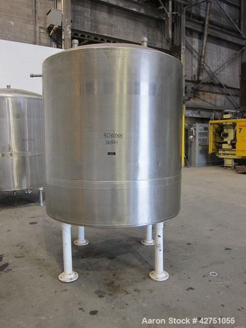 Used Tank, 1000 Gallon, 304 Stainless Steel, Vertical. 66" Diameter x 66" straight side, dished top, coned bottom. Openings top 1-1/2", (2) 2" NPT, (2) 3", 18" man way with cover. 2" Tri-clamp center...